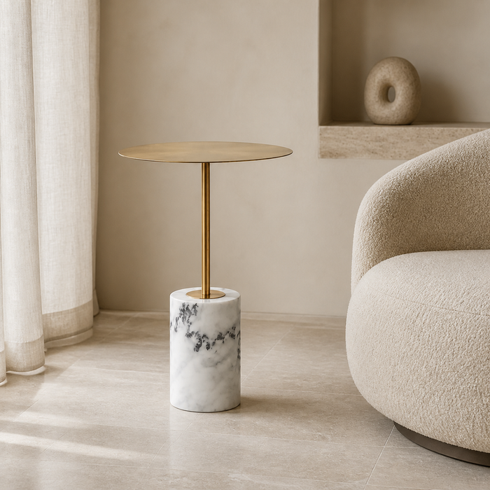 Solenne marble pedestal side table with brushed brass stem in a warm Casa Nuvé interior